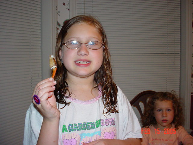 Caroline eating crab claw with Ellyse watching on